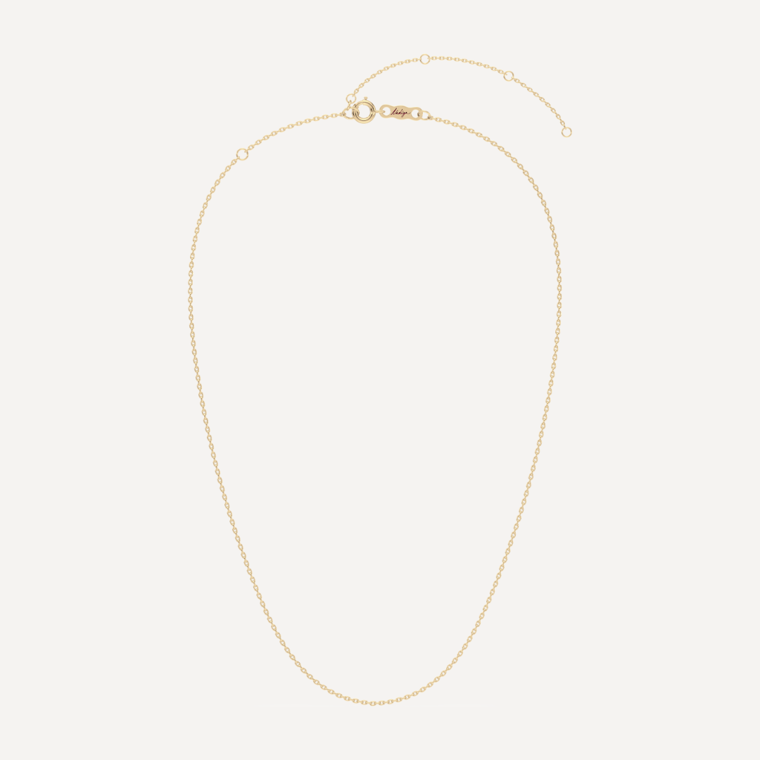 hero image of a solid gold cable angle chain necklace against a cream background