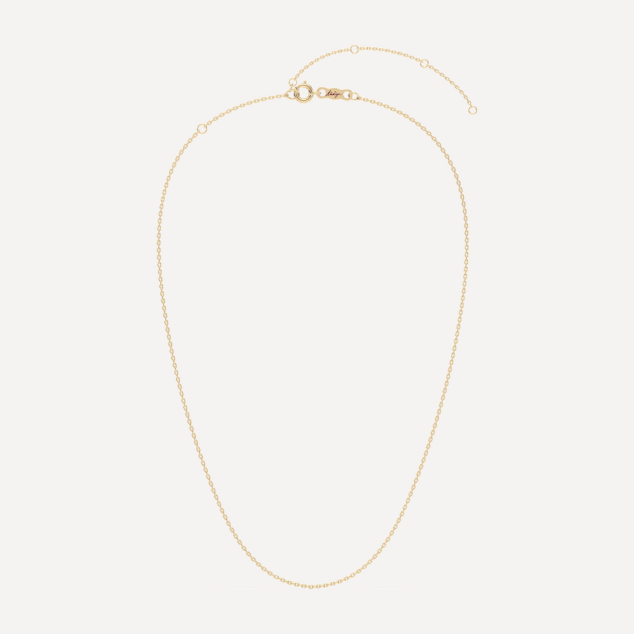 hero image of a solid gold cable angle chain necklace against a cream background 