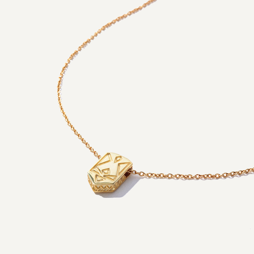 Image alt text: Affirmation Necklaces in 10K solid gold, featuring hidden pattern inspired by Ukrainian embroidery. Versatile and meaningful, perfect for solo wear or layering. Every purchase supports a cause