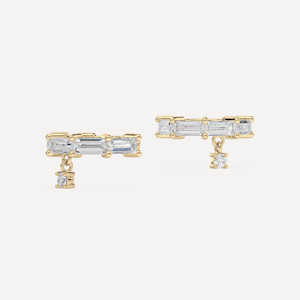 solid gold baguette diamond ear cuffs on a creamy white background by nadiya jewelry