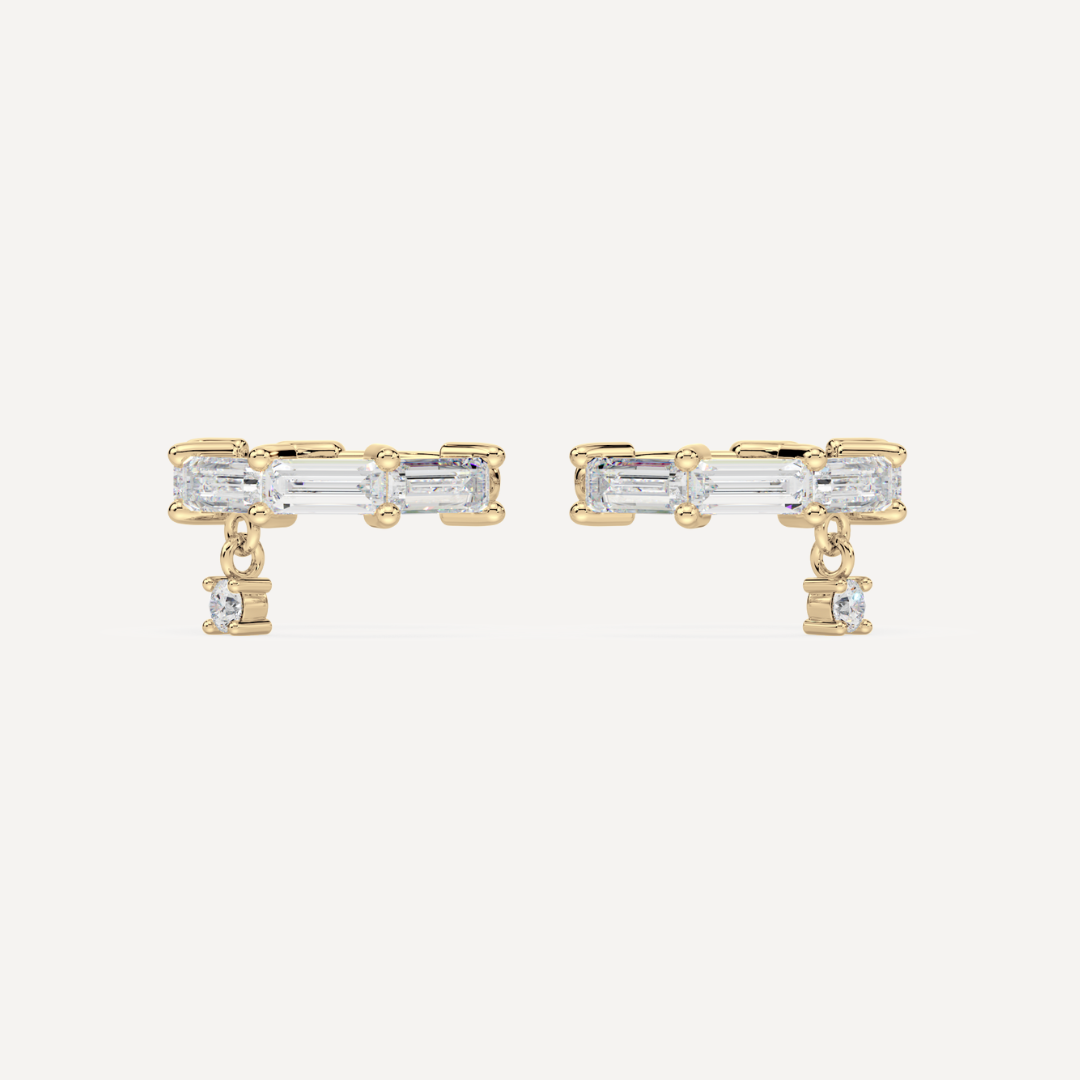 solid gold baguette diamond ear cuffs on a creamy white background by nadiya jewelry
