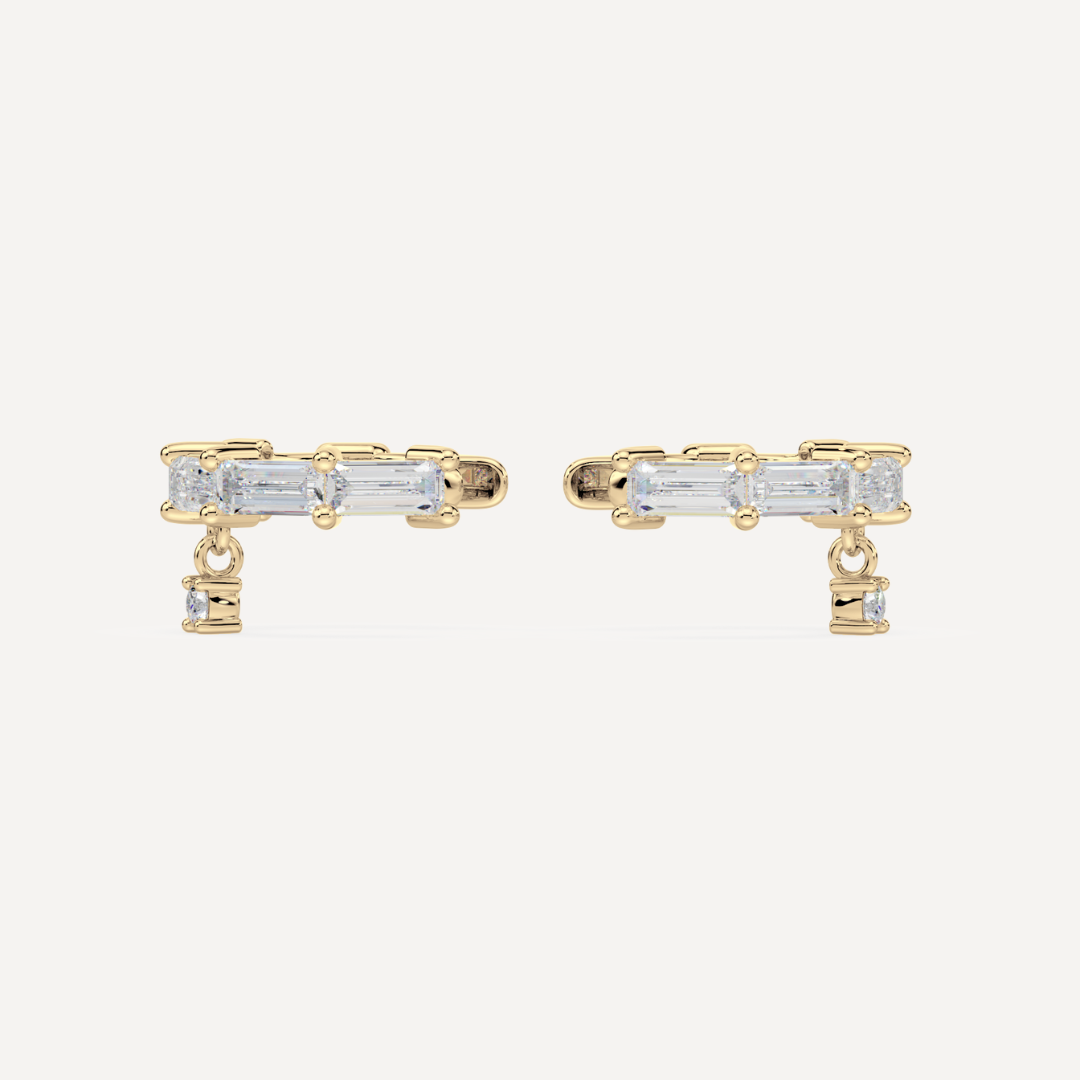 solid gold baguette diamond ear cuffs on a creamy white background by nadiya jewelry