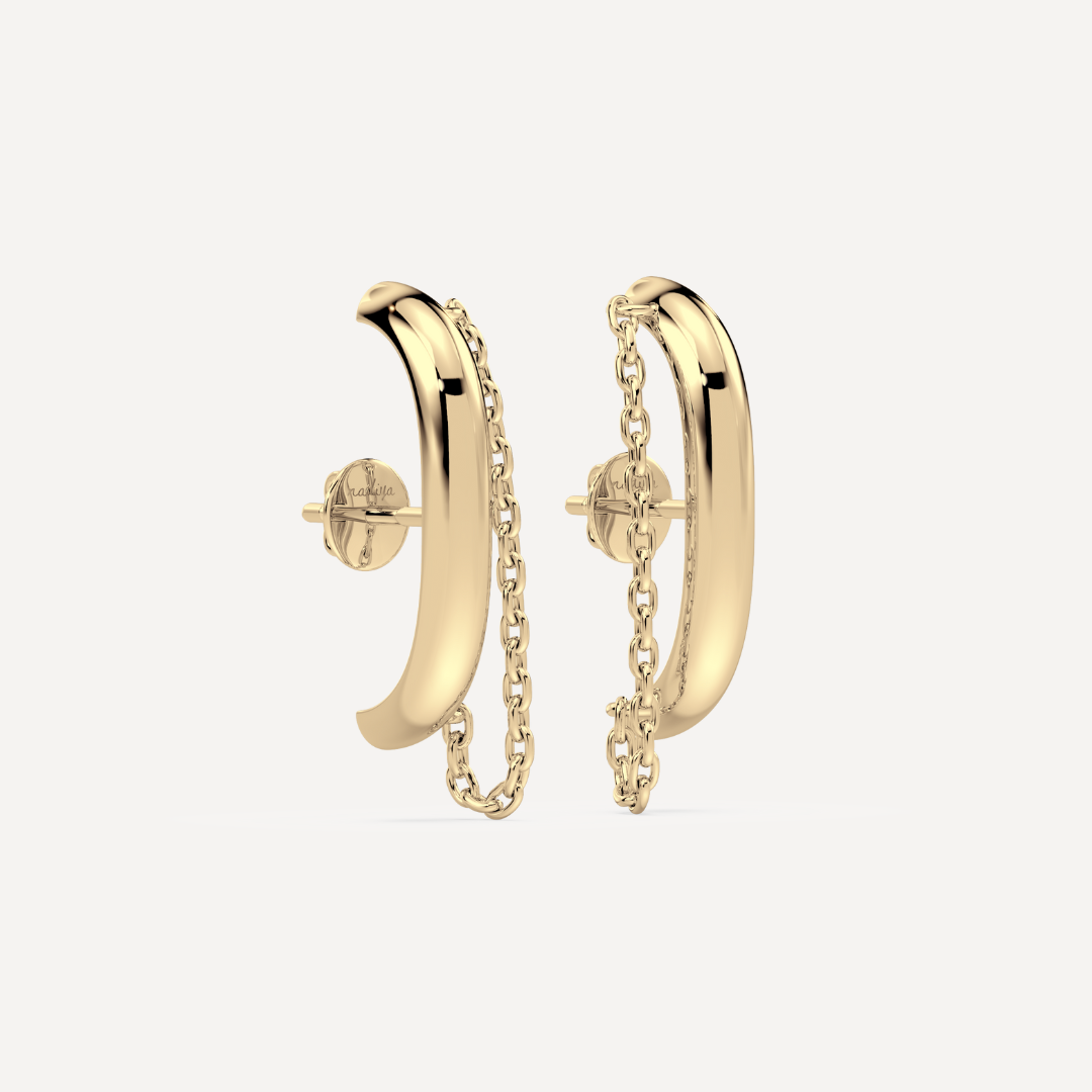 Solid gold ear suspender earrings with chain detail by Nadiya Jewelry on a white background