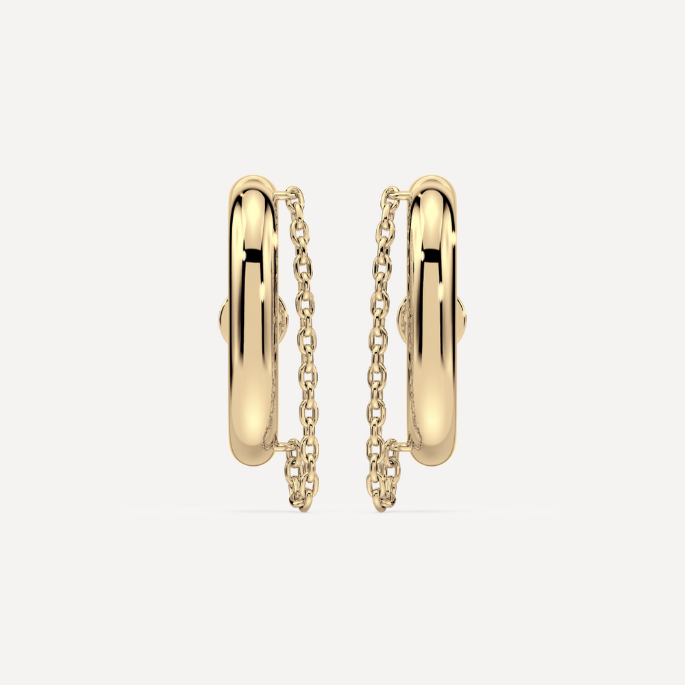 Solid gold ear suspender earrings with chain detail by Nadiya Jewelry on a white background