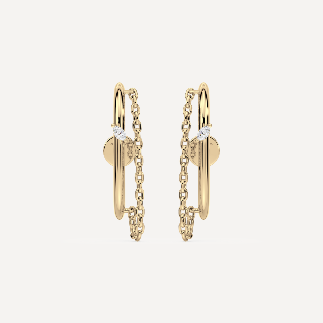 Solid gold ear suspender earrings with chain detail and a marquise diamond by Nadiya Jewelry on a white background