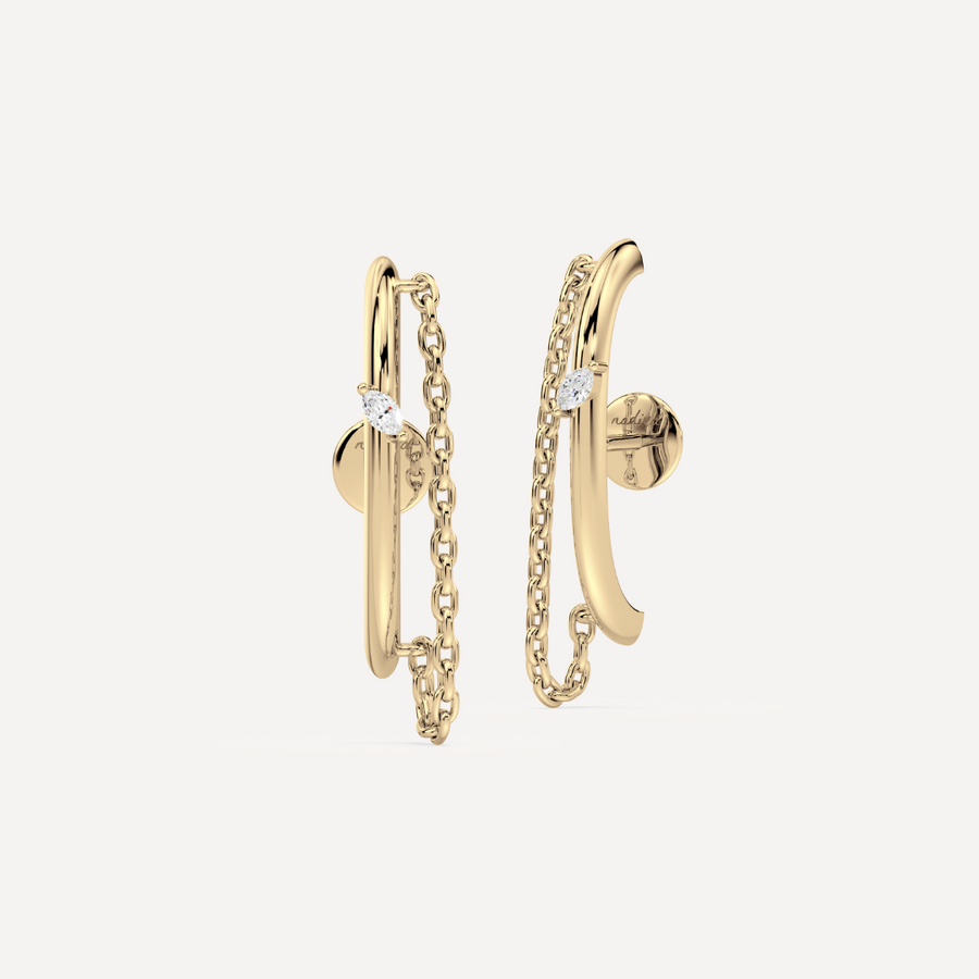 a solid gold earring ear suspender with chain detailing and a marquise diamond by nadiya jewelry 