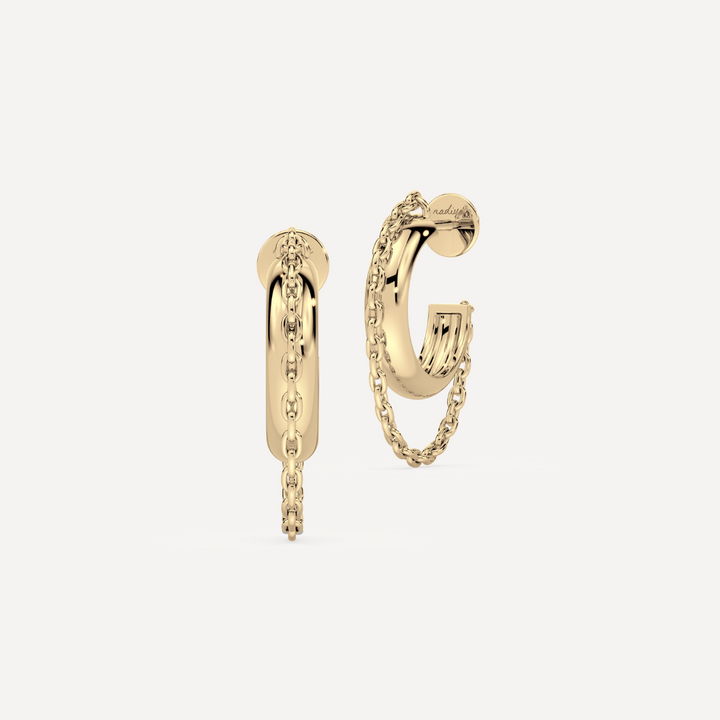 a solid gold hoop earring with chain detailing against a creamy white background