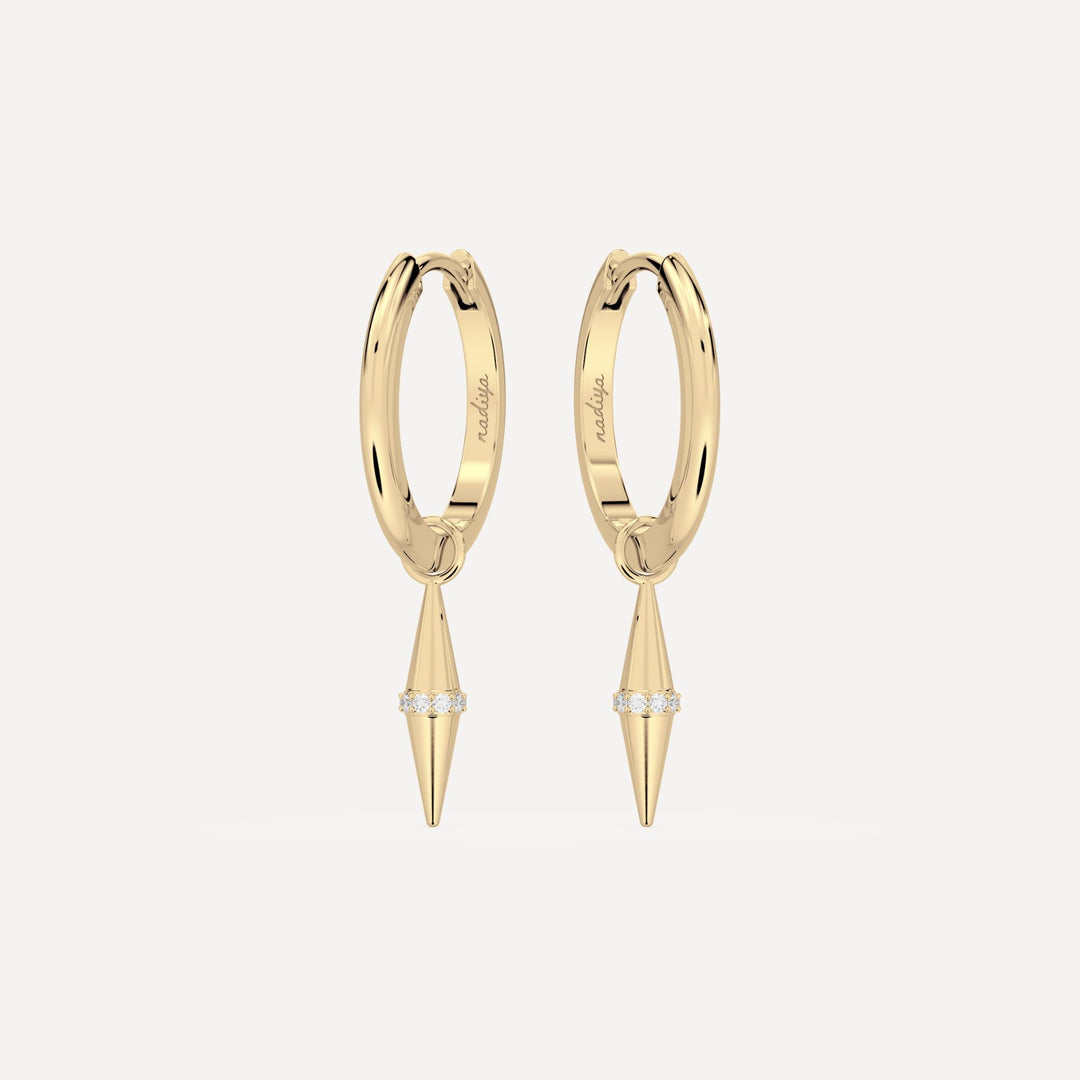 solid gold hoops with solid gold hoop charms and diamonds in a cone shape on white background by nadiya jewelry