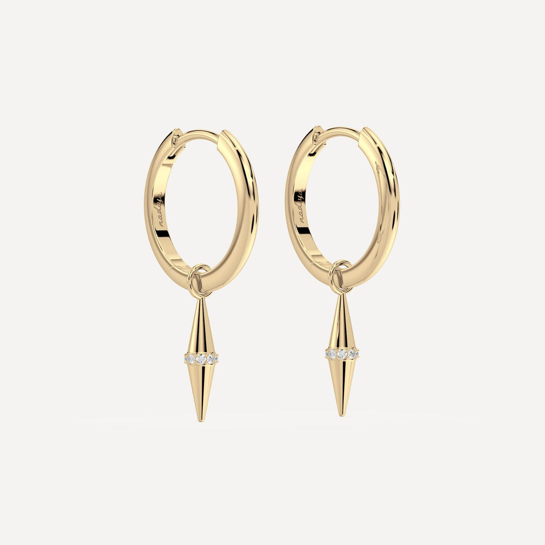 solid gold hoops with solid gold hoop charms and diamonds in a cone shape on white background by nadiya jewelry
