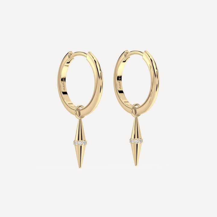 solid gold hoops with solid gold hoop charms and diamonds in a cone shape on white background by nadiya jewelry