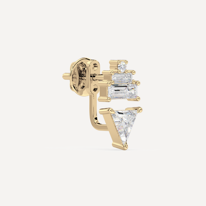 solid gold ladder ear jacket with lab grown diamonds. On the top there’s a round and two baguette diamonds and on the bottom there’s a trillion diamond on a creamy white  background by nadiya jewelry
