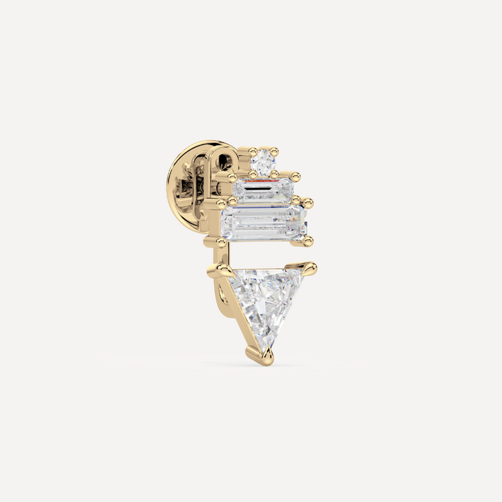 solid gold ladder ear jacket with lab grown diamonds. On the top there’s a round and two baguette diamonds and on the bottom there’s a trillion diamond on a creamy white background by nadiya jewelry