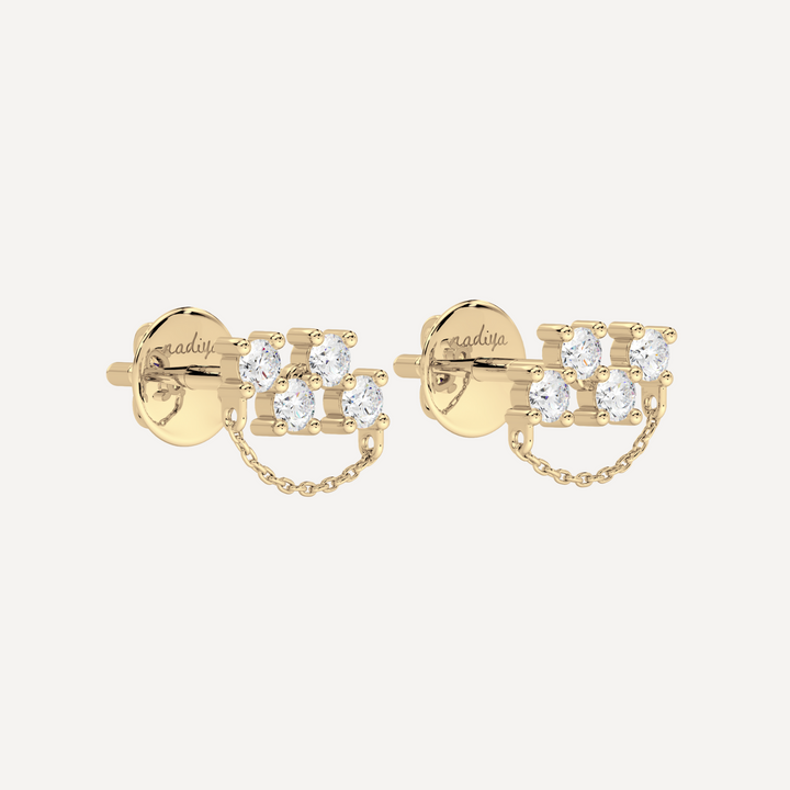 a solid gold earring with diamonds and chain detailing by nadiya jewelry 