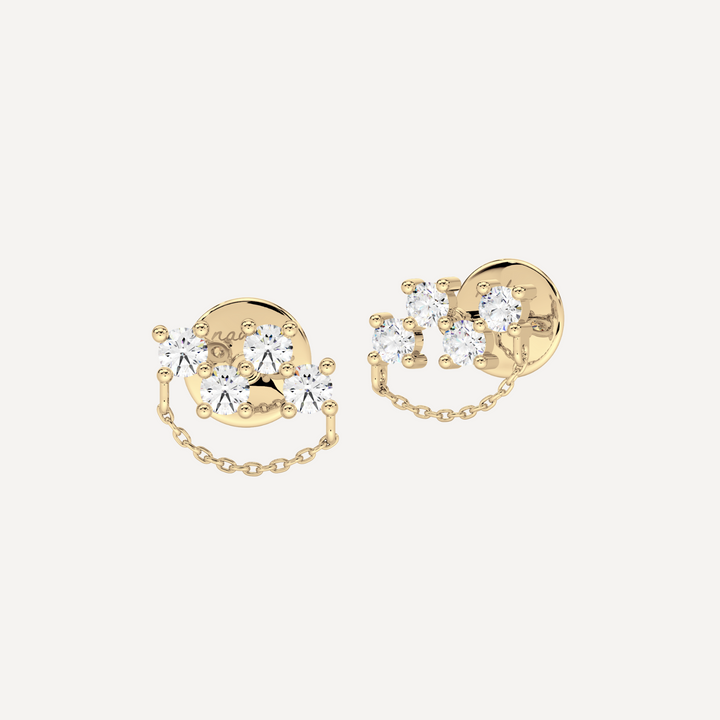 a solid gold earring with diamonds and chain detailing by nadiya jewelry 